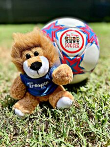 trooper the lion mascot with soccer ball