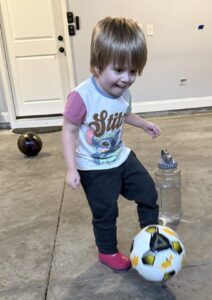 girl passing soccer ball